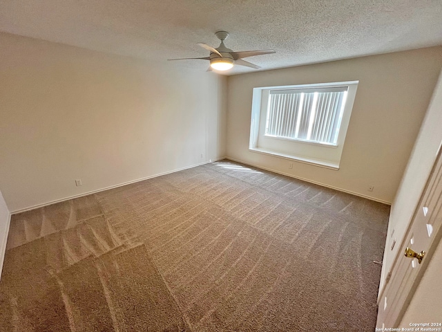 empty room featuring carpet, a textured ceiling, and ceiling fan