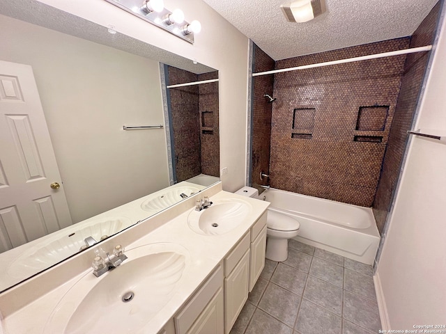 full bathroom featuring a textured ceiling, vanity, tile patterned floors, toilet, and tiled shower / bath combo