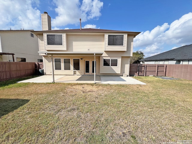 back of house with a yard and a patio area