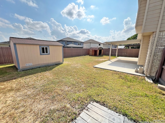 view of yard with a storage unit and a patio