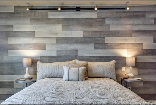 bedroom featuring track lighting