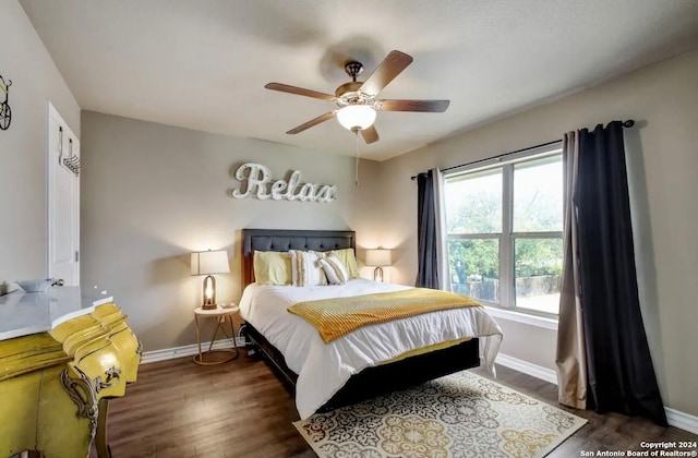 bedroom with dark hardwood / wood-style floors and ceiling fan