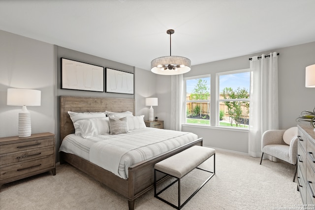 carpeted bedroom with a notable chandelier