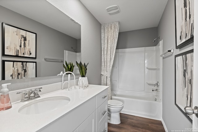 full bathroom featuring hardwood / wood-style floors, vanity, bathing tub / shower combination, and toilet