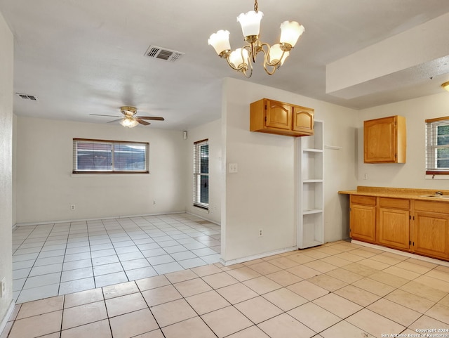 kitchen with built in shelves, hanging light fixtures, light tile patterned flooring, and ceiling fan with notable chandelier