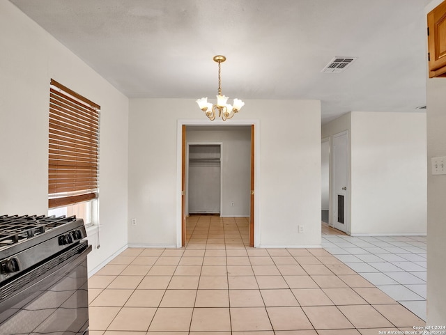 kitchen with black stove, hanging light fixtures, a chandelier, and light tile patterned flooring