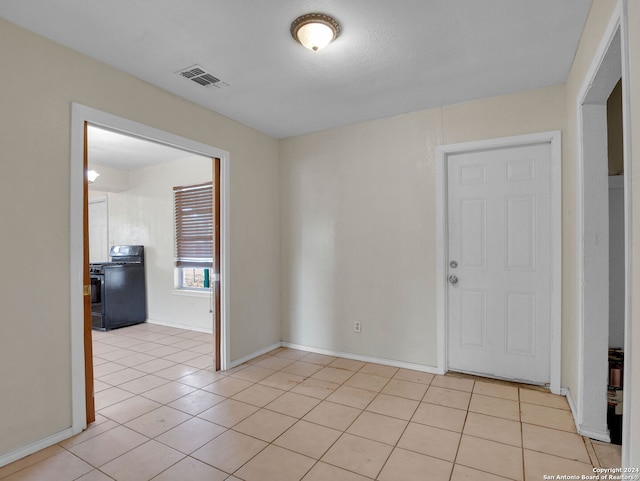 tiled spare room featuring a textured ceiling