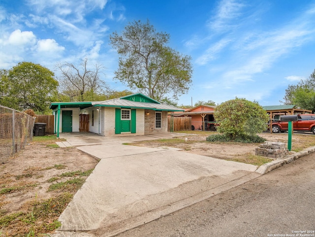 1818 Adamston Dr, San Antonio, TX 78220 - view of front of house featuring concrete driveway, fence, a carport, metal roof, and brick siding