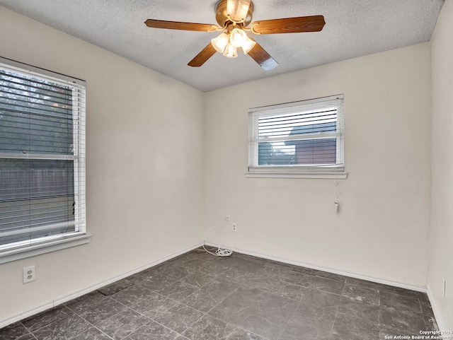 unfurnished room with a textured ceiling and ceiling fan