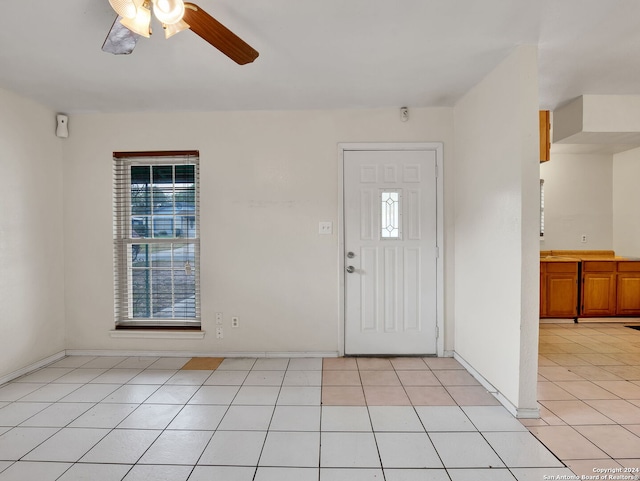 foyer with ceiling fan and light tile patterned flooring