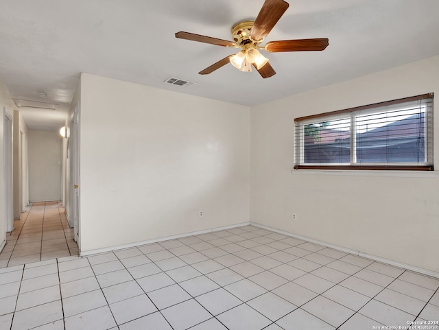 unfurnished room featuring ceiling fan and light tile patterned floors