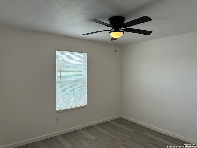 empty room featuring ceiling fan and dark hardwood / wood-style floors