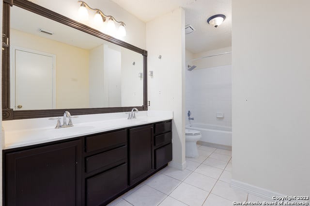 full bathroom with tile patterned flooring, vanity, bathing tub / shower combination, and toilet