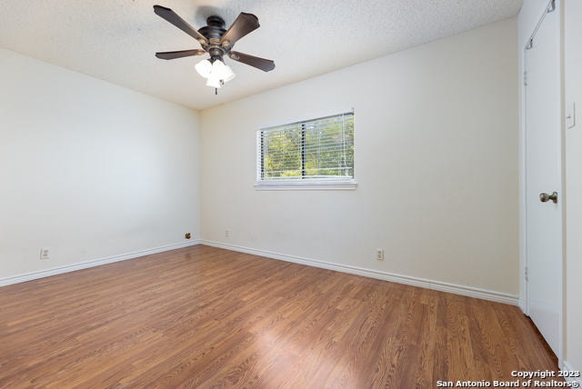 spare room featuring hardwood / wood-style floors, ceiling fan, and a textured ceiling