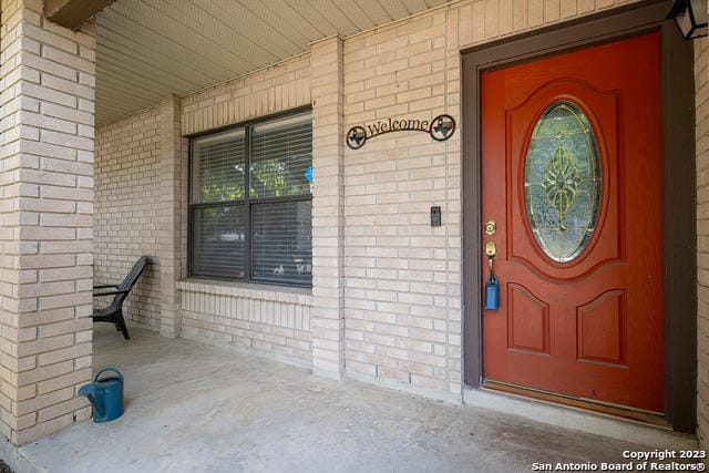 view of exterior entry featuring covered porch