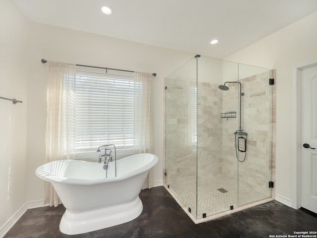 bathroom with shower with separate bathtub and concrete floors