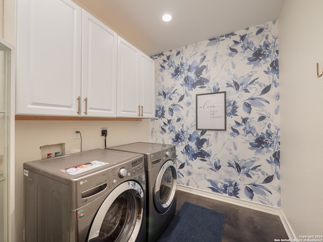 laundry area featuring washer and clothes dryer and cabinets