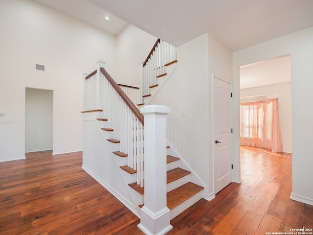 stairway with hardwood / wood-style flooring