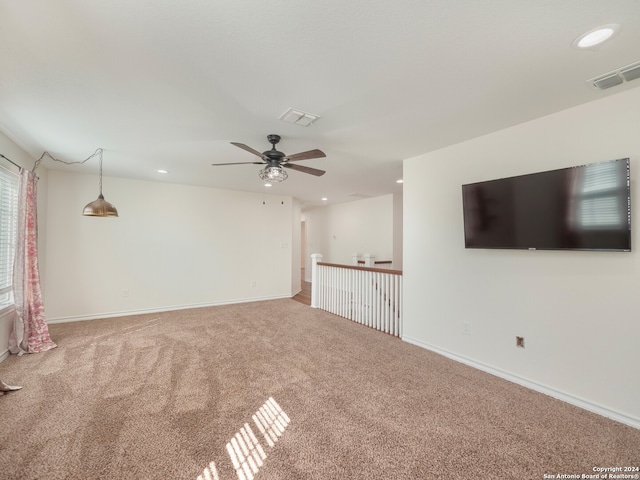 unfurnished living room with ceiling fan and carpet floors