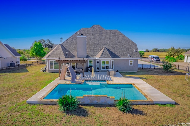 view of pool with a patio, a lawn, and a water slide