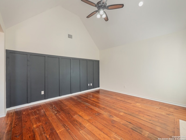 additional living space with high vaulted ceiling, hardwood / wood-style flooring, and ceiling fan