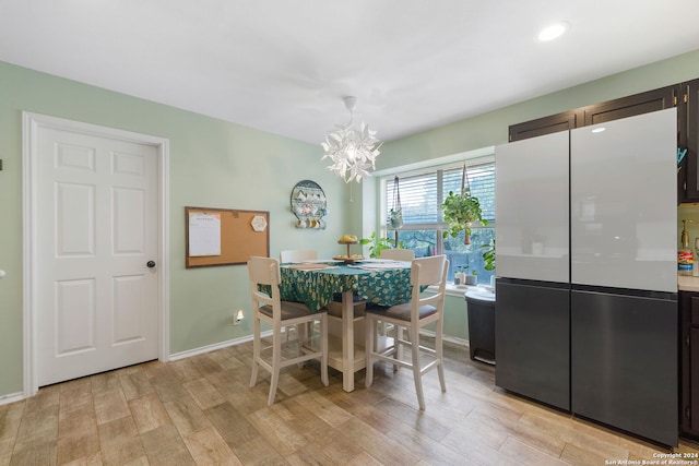 dining area featuring a chandelier and light hardwood / wood-style flooring