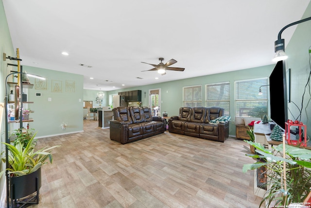 living room featuring light hardwood / wood-style floors and ceiling fan