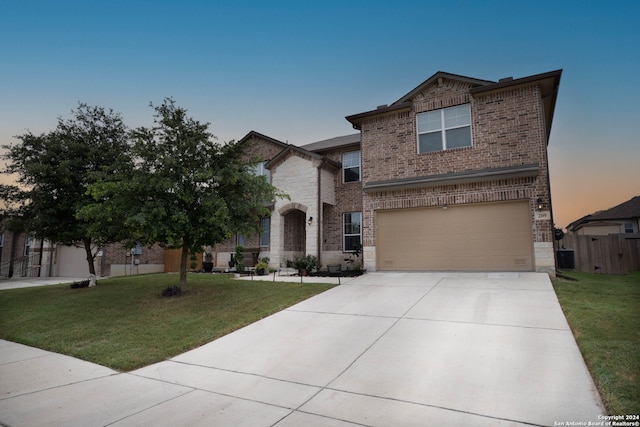 front of property featuring a lawn and a garage