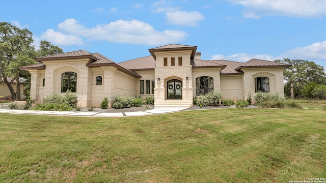 mediterranean / spanish-style house featuring a front yard