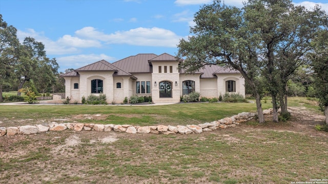 mediterranean / spanish-style house with a front yard