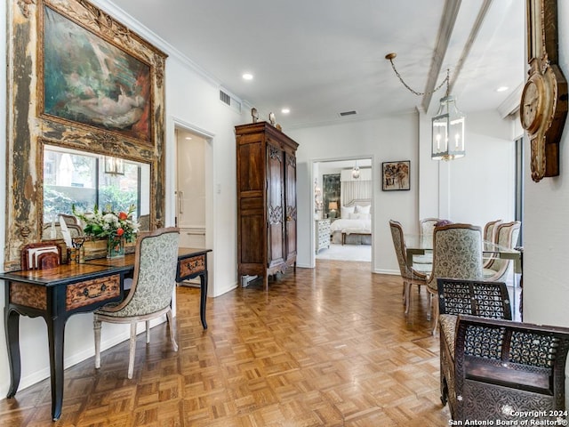 interior space with light parquet flooring, ornamental molding, and a notable chandelier