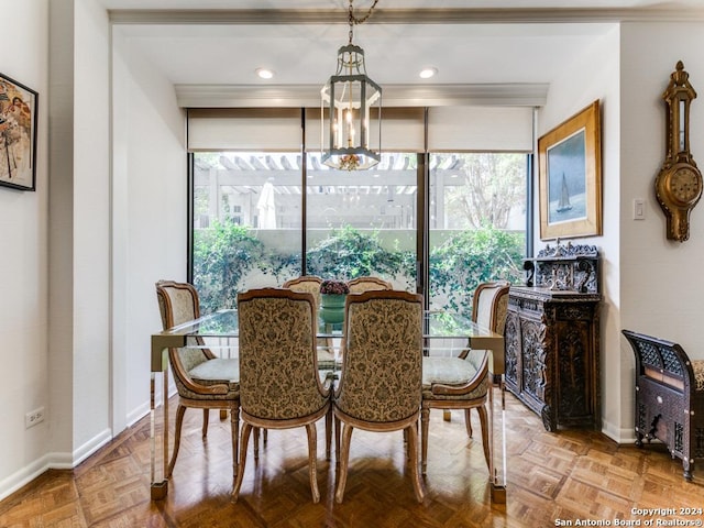 dining space featuring parquet flooring and a chandelier