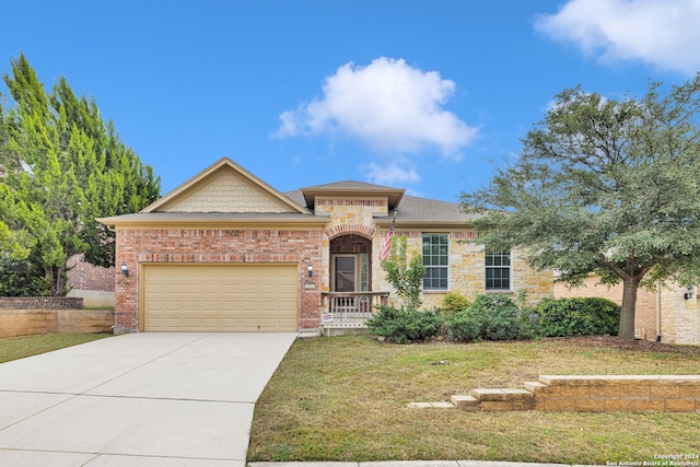 view of front of property with a garage and a front lawn