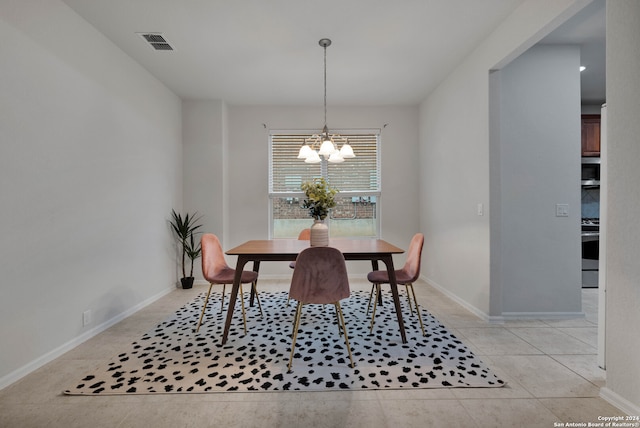 tiled dining space featuring an inviting chandelier