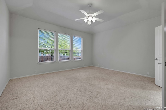 unfurnished room with light colored carpet and ceiling fan