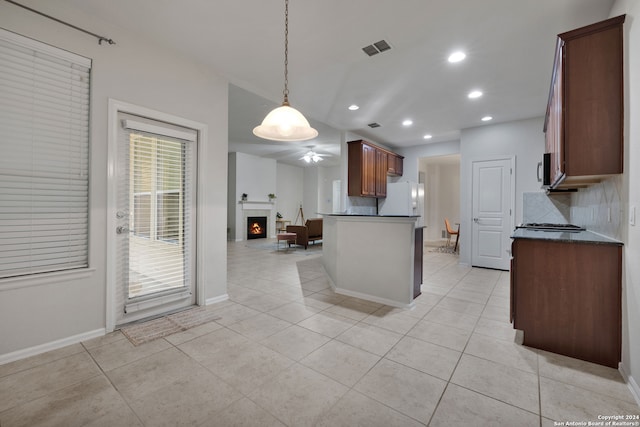 kitchen featuring light tile patterned flooring, pendant lighting, tasteful backsplash, and white fridge