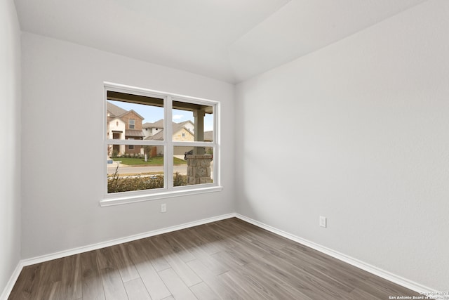 unfurnished room with dark hardwood / wood-style flooring