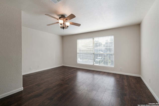 unfurnished room featuring ceiling fan, dark hardwood / wood-style floors, and a textured ceiling