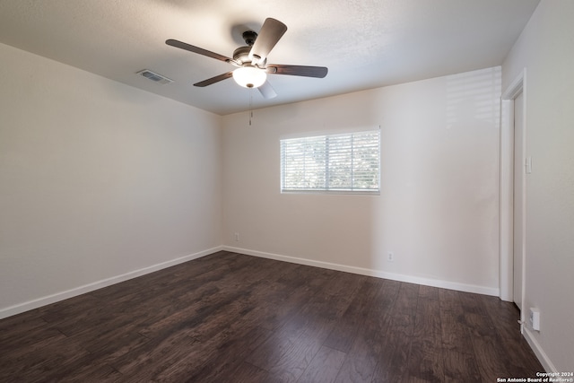 unfurnished room featuring dark wood-type flooring, ceiling fan, and a textured ceiling