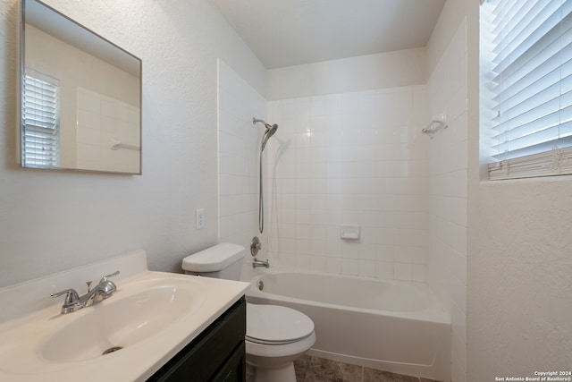 full bathroom featuring toilet, vanity, and tiled shower / bath