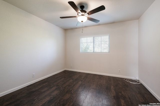 unfurnished room featuring ceiling fan and dark hardwood / wood-style floors