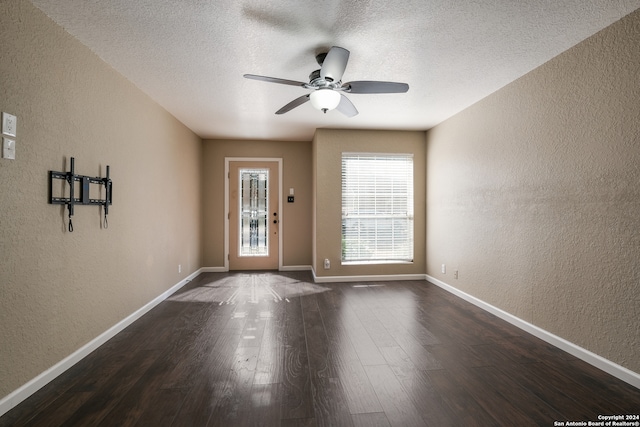 entryway featuring ceiling fan, a textured ceiling, and dark hardwood / wood-style floors