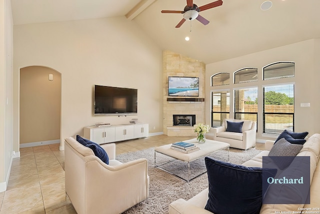 100 Vintage Ranch Cir, La Vernia, TX 78121 - living area featuring high vaulted ceiling, a ceiling fan, arched walkways, light tile patterned floors, and a large fireplace