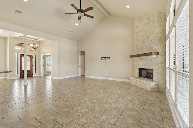 100 Vintage Ranch Cir, La Vernia, TX 78121 - unfurnished living room with high vaulted ceiling, a ceiling fan, plenty of natural light, a stone fireplace, and beamed ceiling