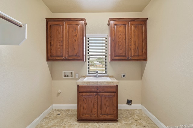 washroom featuring sink, cabinets, hookup for an electric dryer, gas dryer hookup, and hookup for a washing machine