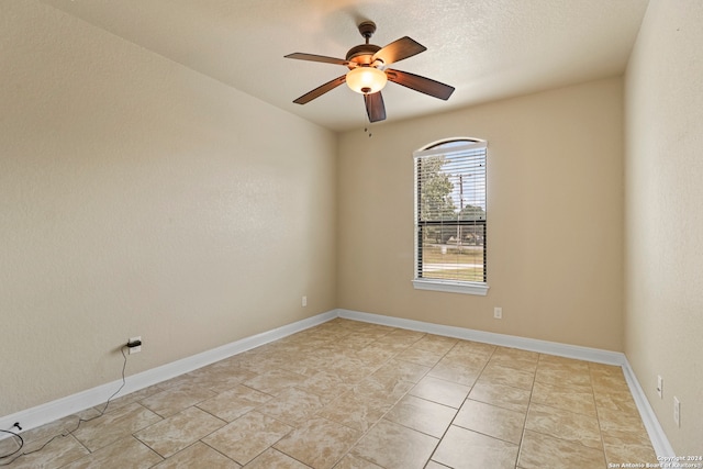 unfurnished room featuring ceiling fan and a textured ceiling