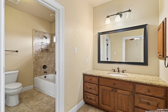 full bathroom featuring ceiling fan, tiled shower / bath combo, tile patterned floors, toilet, and vanity