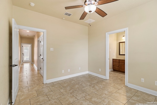 unfurnished bedroom with ensuite bath and ceiling fan