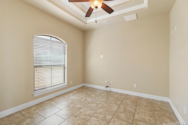 unfurnished room featuring ceiling fan, a raised ceiling, and crown molding