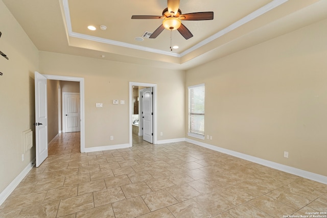 unfurnished bedroom featuring a tray ceiling, ceiling fan, and ornamental molding